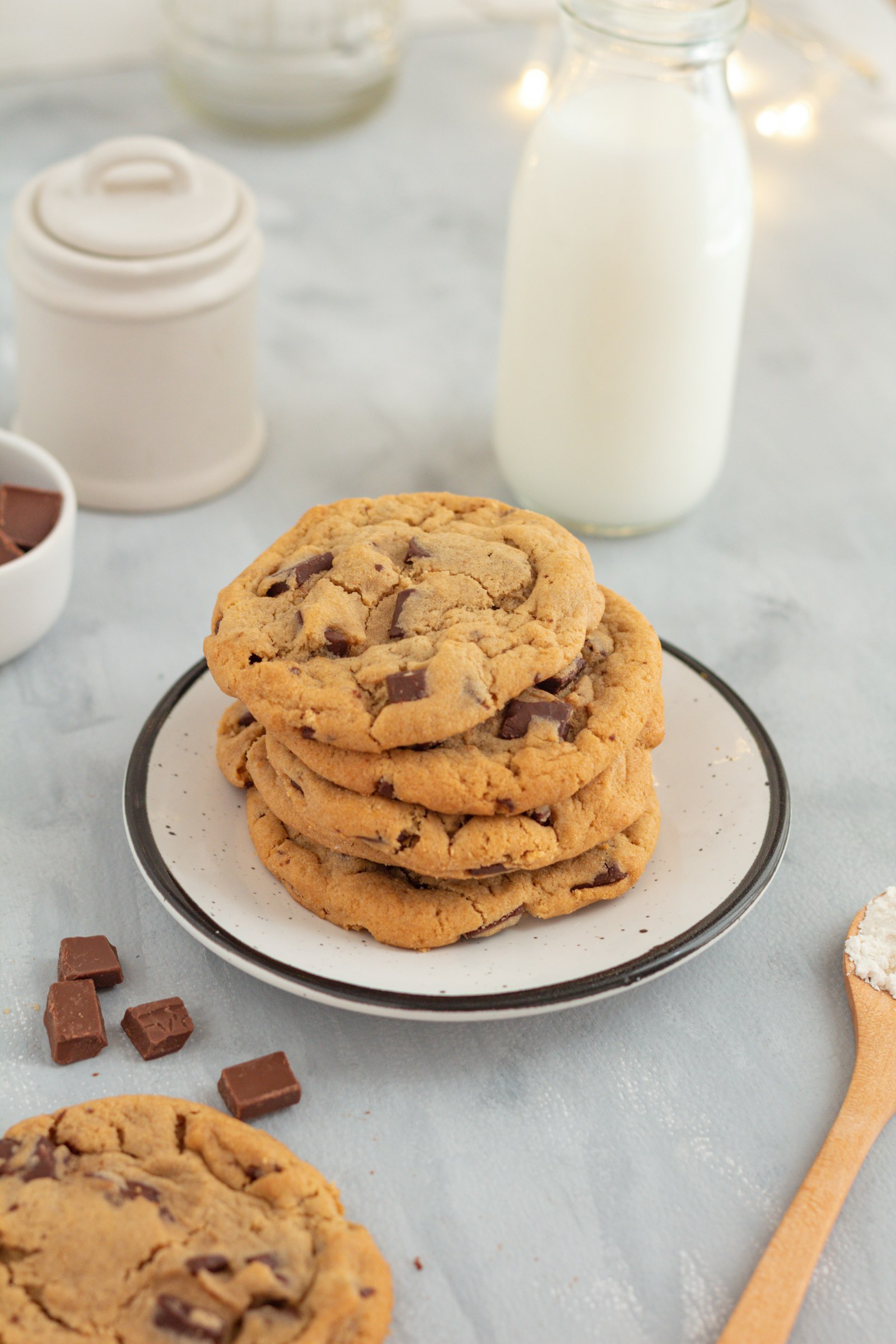 A stack of cookies with a glass of milk